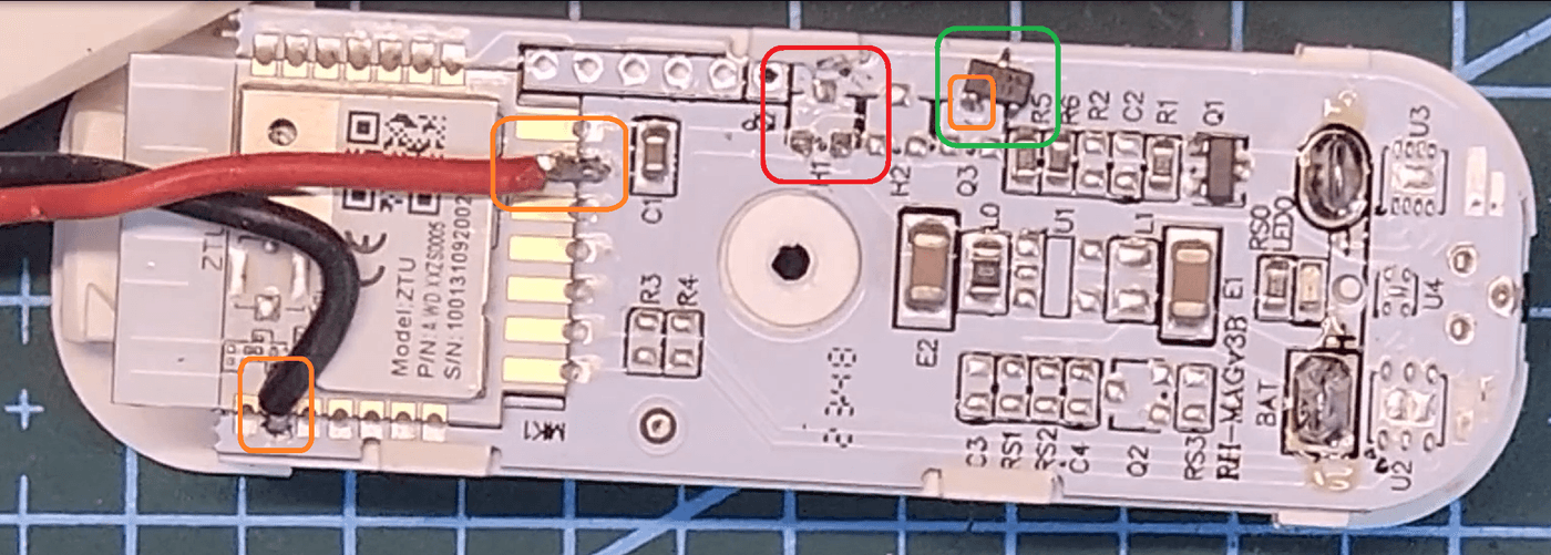 Zigbee door sensor PCB modified for an external contact — callouts show the removed chip, where it was parked, and the new wire joints
