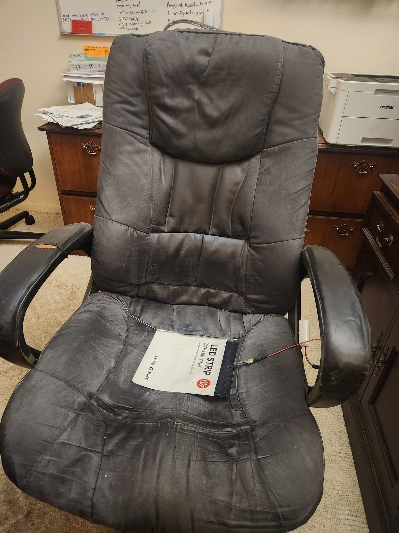The pressure mat sealed inside the bag and set on the office chair, wired out to the modified Zigbee sensor