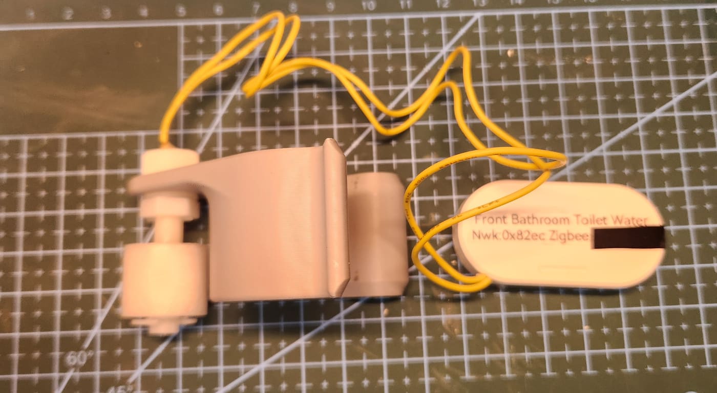 The float switch and modified Zigbee sensor dry-fit assembled on the bench before installation